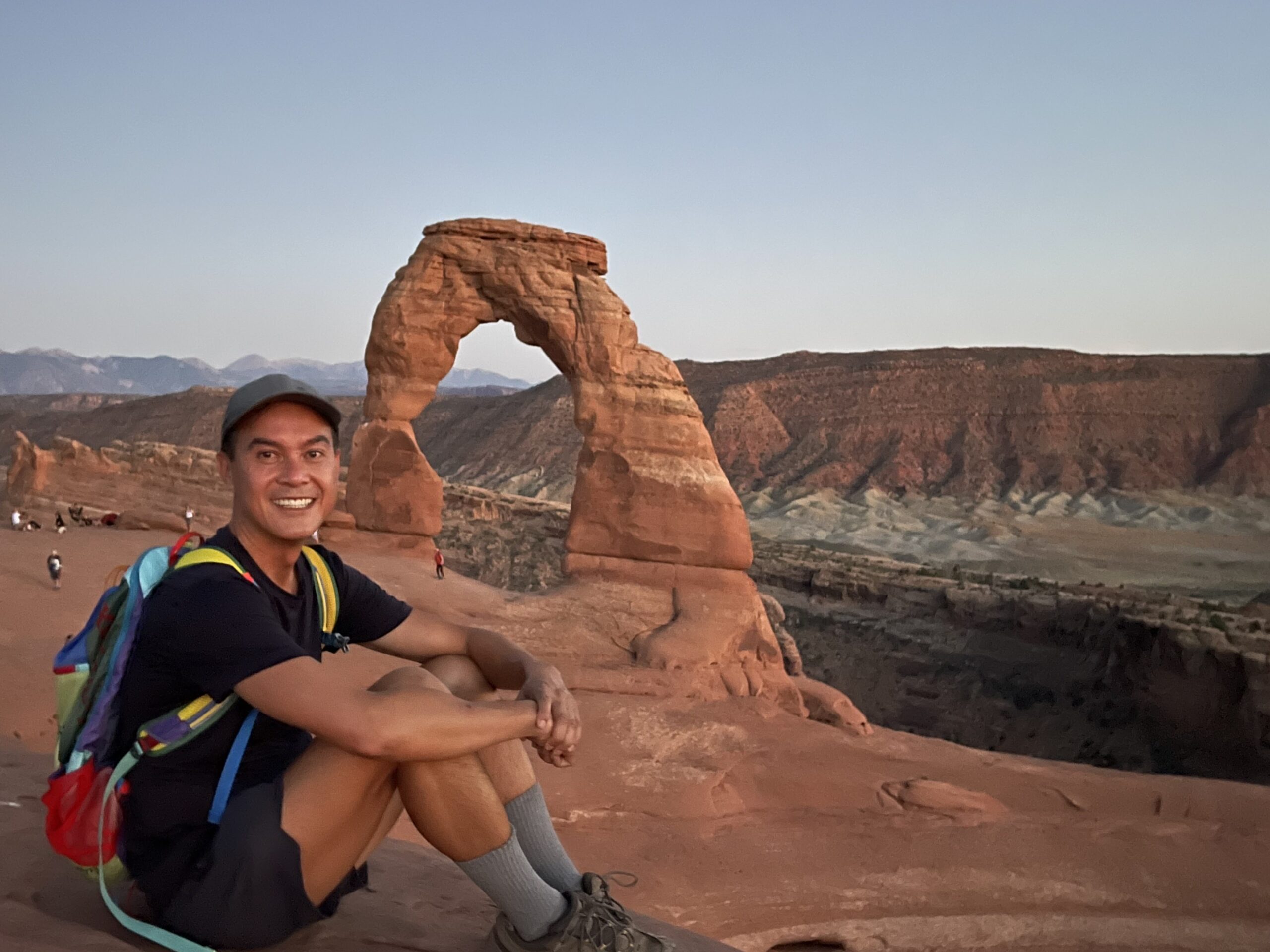 Paul posing in front of Delicate Arch in Arches National Park.