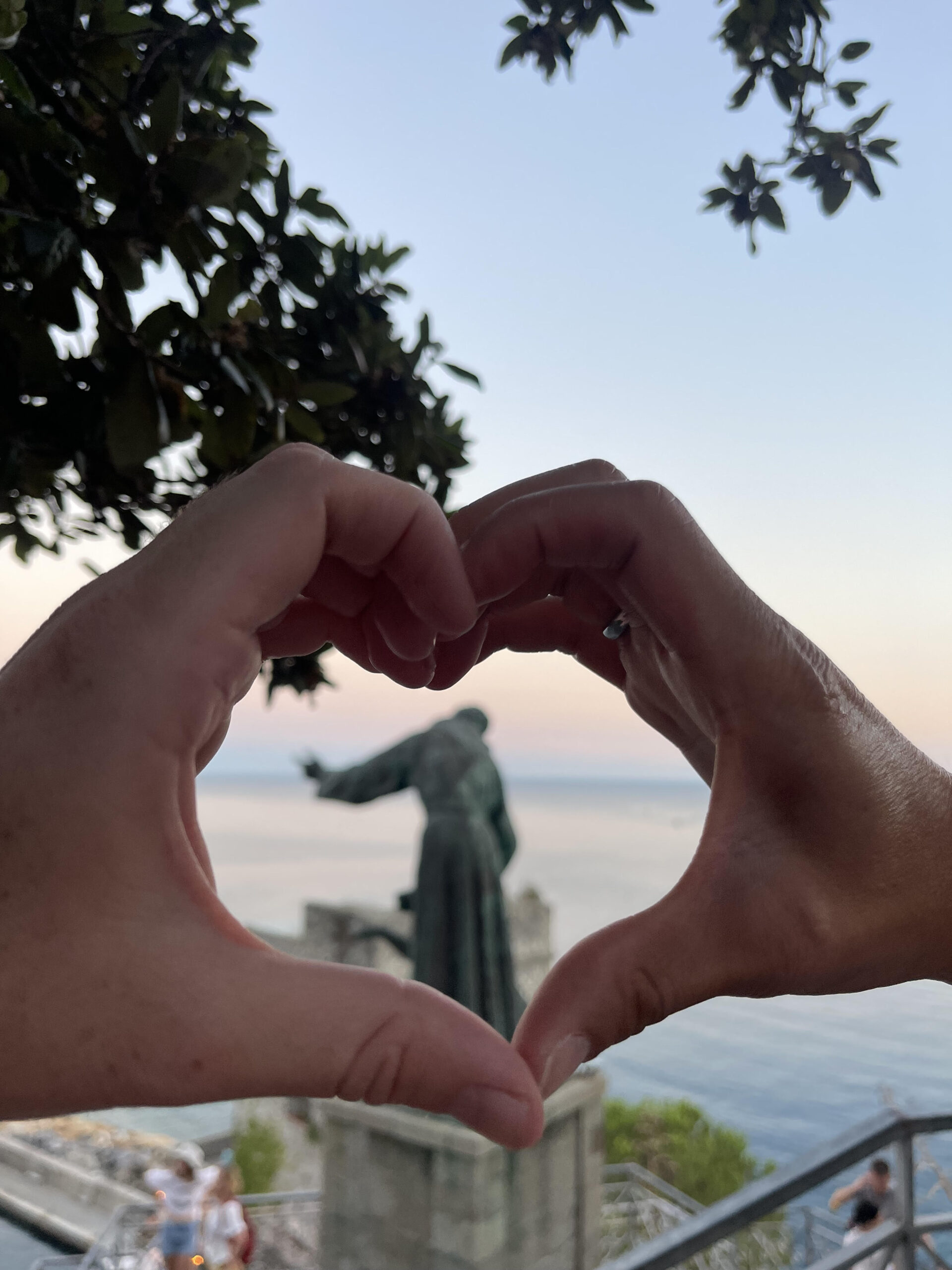 The view atop the monastery where Jordan proposed to Paul, seen through the couples hands making a heart.